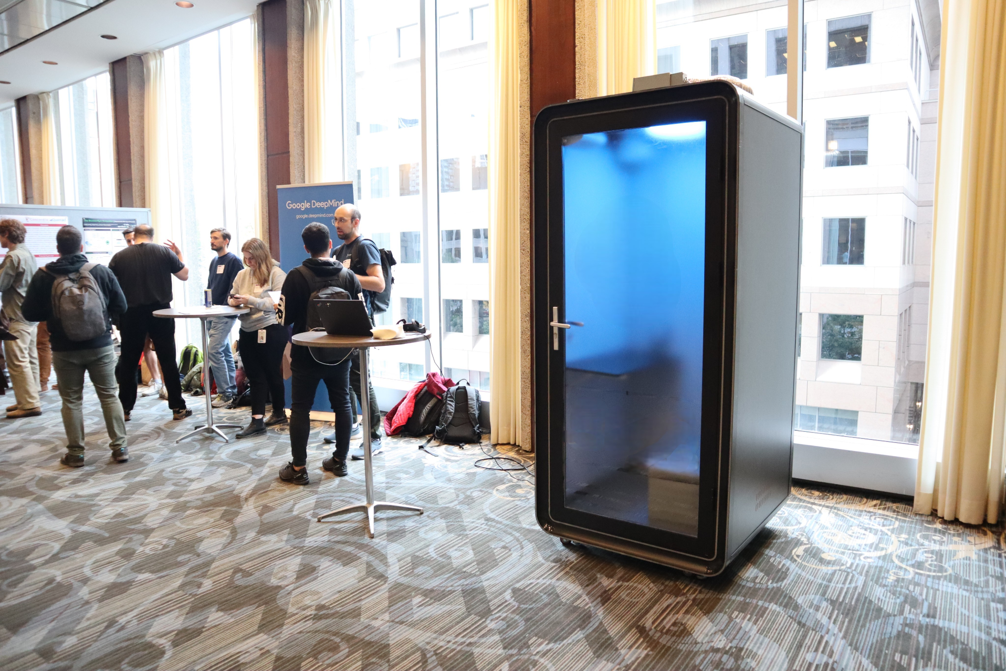 Ouvertu privacy pod in a busy open-plan office, a quiet corner amid activity