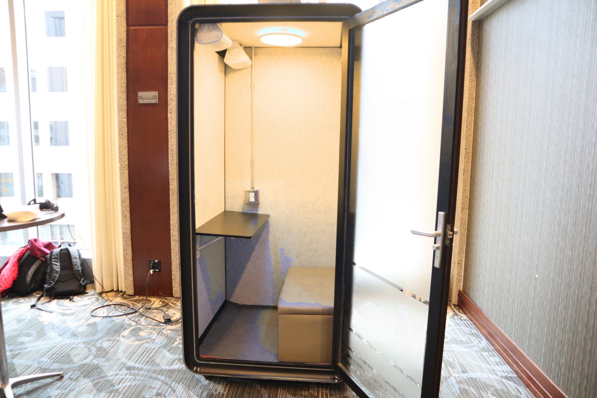 Interior of the Ouvertu pod with fold-down desk and warm ambient lighting